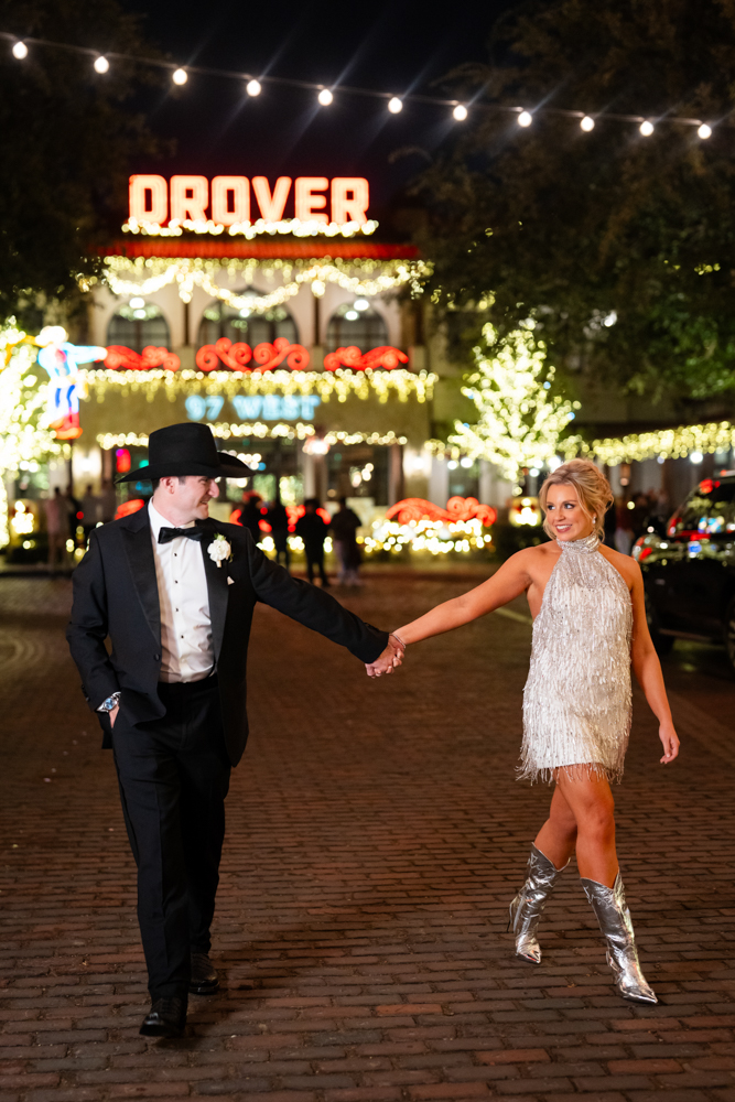 late night portraits outside the hotel drover in the fort worth stockyards at christmas for their wedding