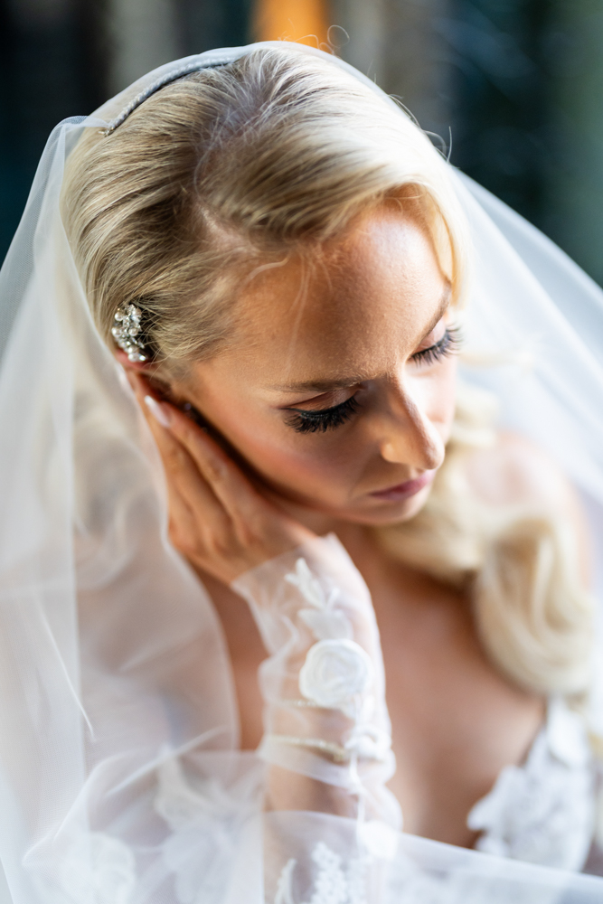 Bride touching her earring at The Fort Worth Club bridal session