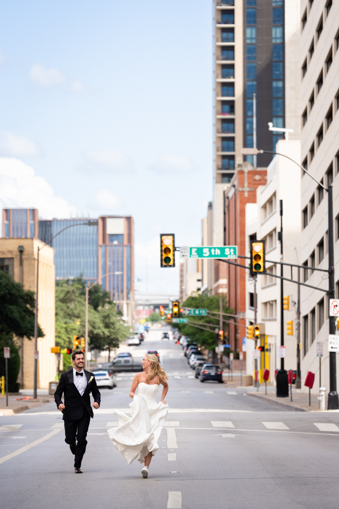 The newlyweds running down the streets of downtown fort worth outside of bass hall in tribute to Taylor Swift.
